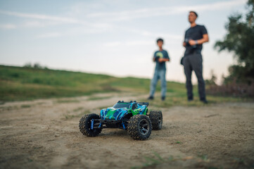 Selective focus on a toy car with family in a blurry background.