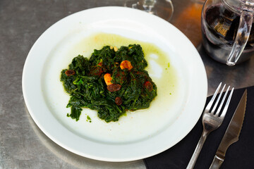 Catalan Spinach served on table with serving pieces