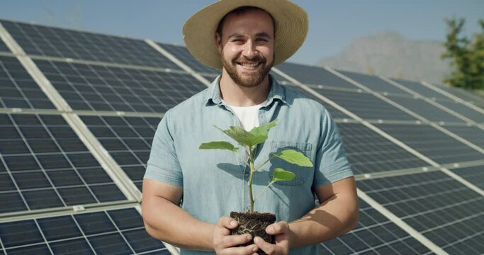 Solar panel, portrait and farmer with plant for green ecology, agriculture and clean renewable energy in summer. Photovoltaic, electricity and smile of man in nature for eco friendly power generation