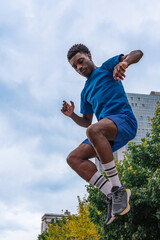Young African American athlete mid-jump