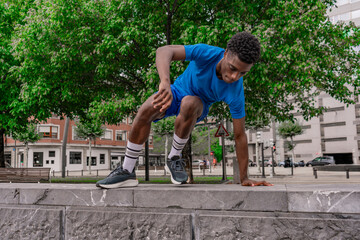 Young African American athlete mid-jump