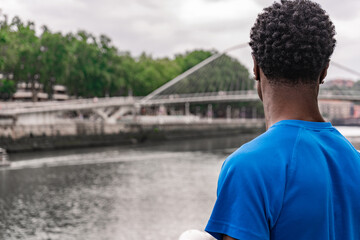 Contemplating Horizons: Thoughtful Young African American Gazing at the Bridge in the Distance