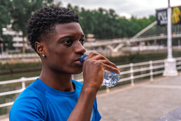 Active Hydration: Young African American Recharging with Fresh Water