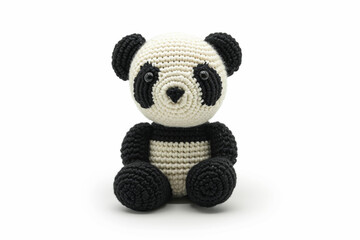 Amigurumi little panda bear. Handicraft cute crocheted doll. Isolated on white background.