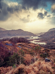 Wonderful nature scene with mountains and dark dramatic sky. Ladies view, Killarney, Ireland, ring of Kerry route. Magnificent Irish nature and popular travel and tourist area. Cinematic look.
