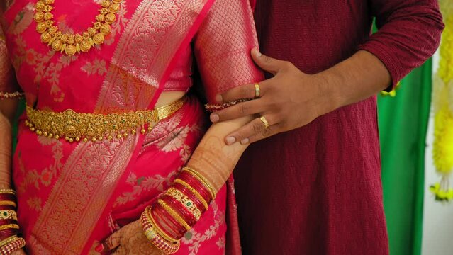  Couple standing together. Woman in traditional Indian dress hindu wedding.. Close up