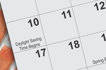 Daylight saving time on a calendar page - obrazy, fototapety, plakaty
