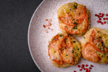Delicious baked fish fillet with cheese, tomatoes, salt, spices and herbs