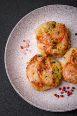 Delicious baked fish fillet with cheese, tomatoes, salt, spices and herbs