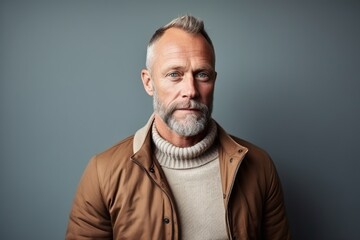 Portrait of a senior man with grey hair and beard. Studio shot.