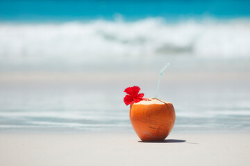 Tropical fresh coconut cocktail on white beach. Holiday and vacation concept. Tropical beach.