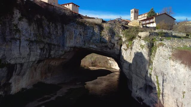 Aerial view of Puentedey, a picturesque village with a natural bridge over the river. Burgos, Spain. High quality 4k footage