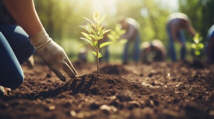 Closeup of a group of hands holding onto shovels, working together to plant trees in a community park. - Powered by Adobe
