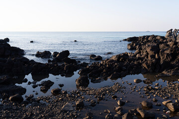 seaside rocks with the sea horizon in the afternoon