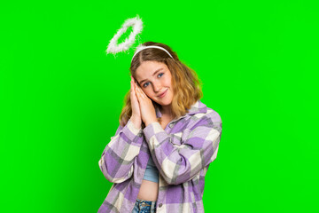 Portrait of smiling shy angelic young caucasian woman with angel halo nimb over head flirting, looking at camera, positive love emotions, celebrating holiday. Redhead girl on chroma key background