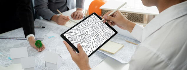 Fototapeta na wymiar Worker, architect and engineer work on real estate construction project oratory planning with cartography and cadastral map of urban town area to guide to construction developer business plan of city