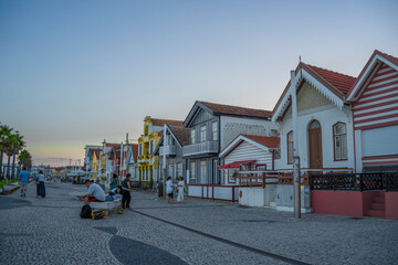 Colorful houses in Aveiro in Portugal, beautiful sky, people walking, sunset