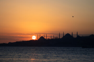 Fototapeta premium View of Istanbul's historical peninsula at sunset. View of the Sultanahmet Mosque located on the historical peninsula in silhouette.