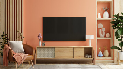 Mockup a TV wall mounted in pastel tone peach fuzz color wall