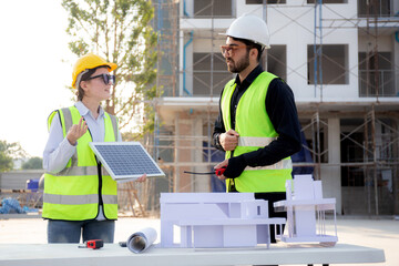 Team young engineer or architect meeting and planning installation solar panel at construction site, engineer talking and discussing with partner for installation solar cell, industry concept. - obrazy, fototapety, plakaty