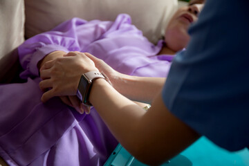 Closeup hands caregiver woman or doctor encourage and care senior while lying on sofa in living...