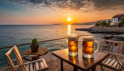 Zelfklevend Fotobehang Sipping a fresh beer waiting to admire the fantastic sunset on the beach cafe © Callow