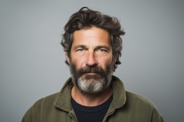 Handsome middle age man with long beard and mustache, studio shot