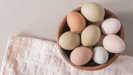 Basket of chicken eggs on the table, colorful big eggs, organic food, natural protein