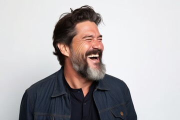 Portrait of a handsome man with long gray beard and mustache laughing
