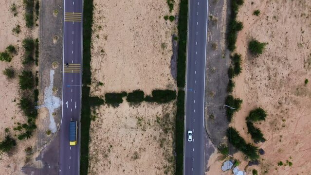 The two roads are parallel and the car runs at an aerial angle from the drone. Concept of tourism and transportation.