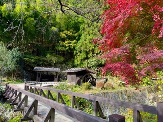 An antique water wheel on the side of the road in a historical town called Magome in Japan