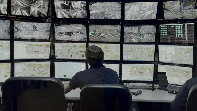 Traffic Office with monitors. Media. Traffic data on monitors in city planning office. Employee monitors monitors from traffic surveillance cameras in city