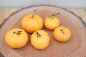Fresh tangerines on a wooden background. Selective focus.