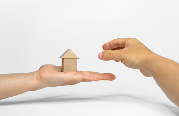 Two hands positioning wood blocks on white background. business or creative concept