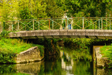 River with bridge. Coulon town in France