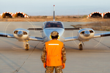 aircraft Piper Seneca II ready to taxi with ground personnel clearance.