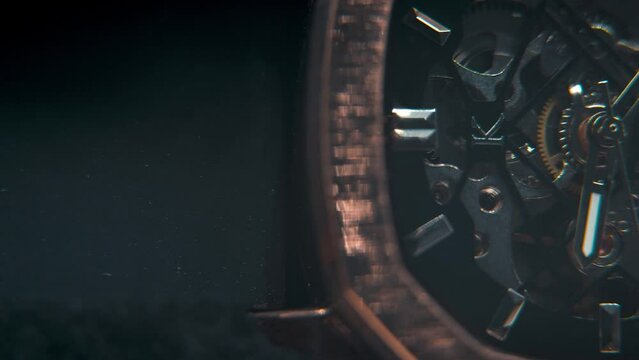 A macro slose-up shot of a mechanic hand watch, vintage technology, retro mechanism, octagon goden design, cinematic studio lighting, commercial footage, detailet 4K video, pan right
