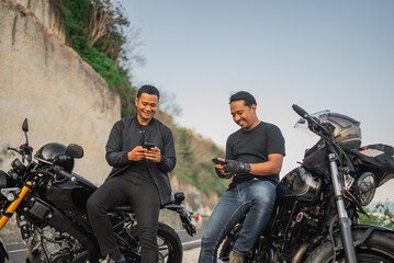 Fototapeta na wymiar happy indonesian riders watching phone together while traveling together