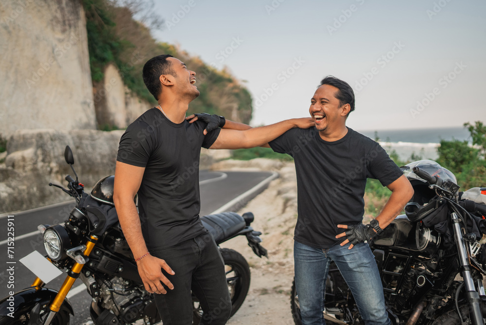 Wall mural asian riders standing beside motorcycle