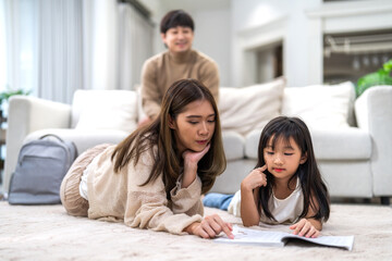 Portrait happy love asian family mother teach little daughter asian girl learn and study.Mom and asian young girl reading book and pencil making lessons in homeschool at home.Education.