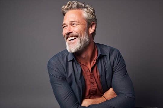 Portrait of a handsome mature man laughing and looking at the camera.