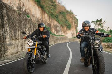Fototapeta na wymiar happy indonesian bikers traveling together by riding a motorcycle