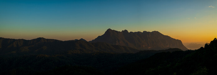 Panoramic beautiful sunrise landscape from the forest in the national park. Big mountain of Thailand.