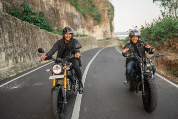 Fototapeta na wymiar indonesian men enjoying riding motorcycle outdoors, motorcycle adventure concept