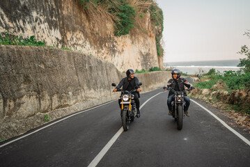 indonesian man having road trip riding motorcycle together with friend