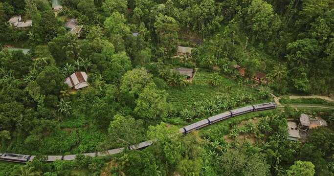Ella Sri Lanka Aerial v17 cinematic birds eye view drone flyover bedside moving railway train capturing hillside resort hotels surrounded by lush greenery - Shot with Mavic 3 Cine - April 2023