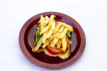 Fresh lettuce and tomato with potato chips on a slice of white bread toast
