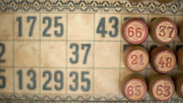 Cinematic close-up smooth pan right shot of a Bingo wooden barrels, woody figures, on a old numbers textured background, vintage board game, lucky number, professional lighting, slow motion 120 fps