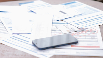Piles of invoice bills or mortgage notification papers as modern financial over spending lifestyle...