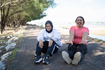 happy asian women warming up together before exercise